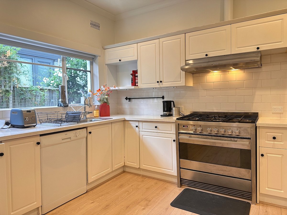 Fully equipped kitchen with gas range and garden outlook